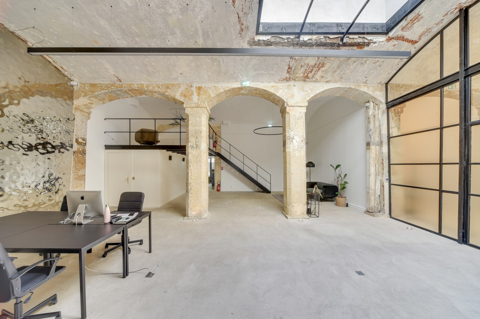 Renovated high-ceiling space with archs and old stones