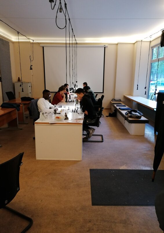 Minimalistisch eingerichteter Coworking Cafe mit Feinkostküche, großer Auswahl von Winzerweine, mit großen Fenstern und grüner Terrasse