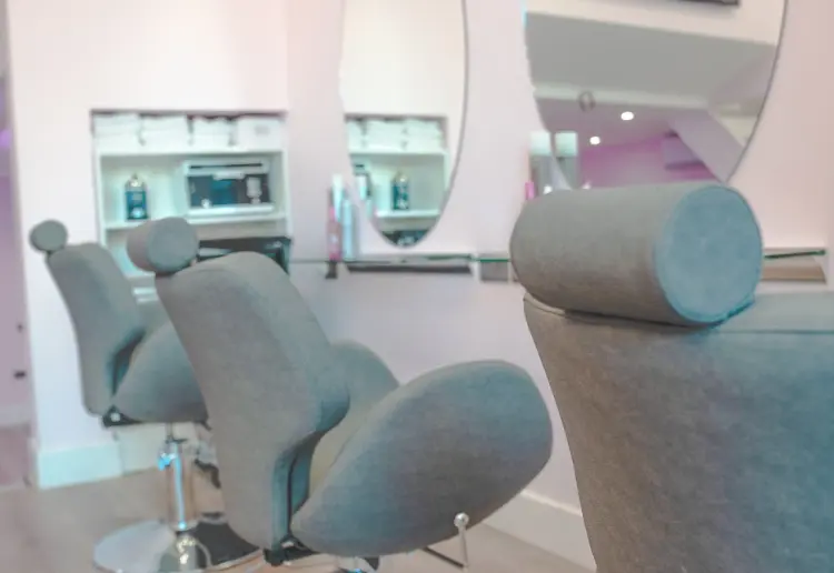 Spacious two-level salon with a big storefront window, offering a unique, elevated experience.