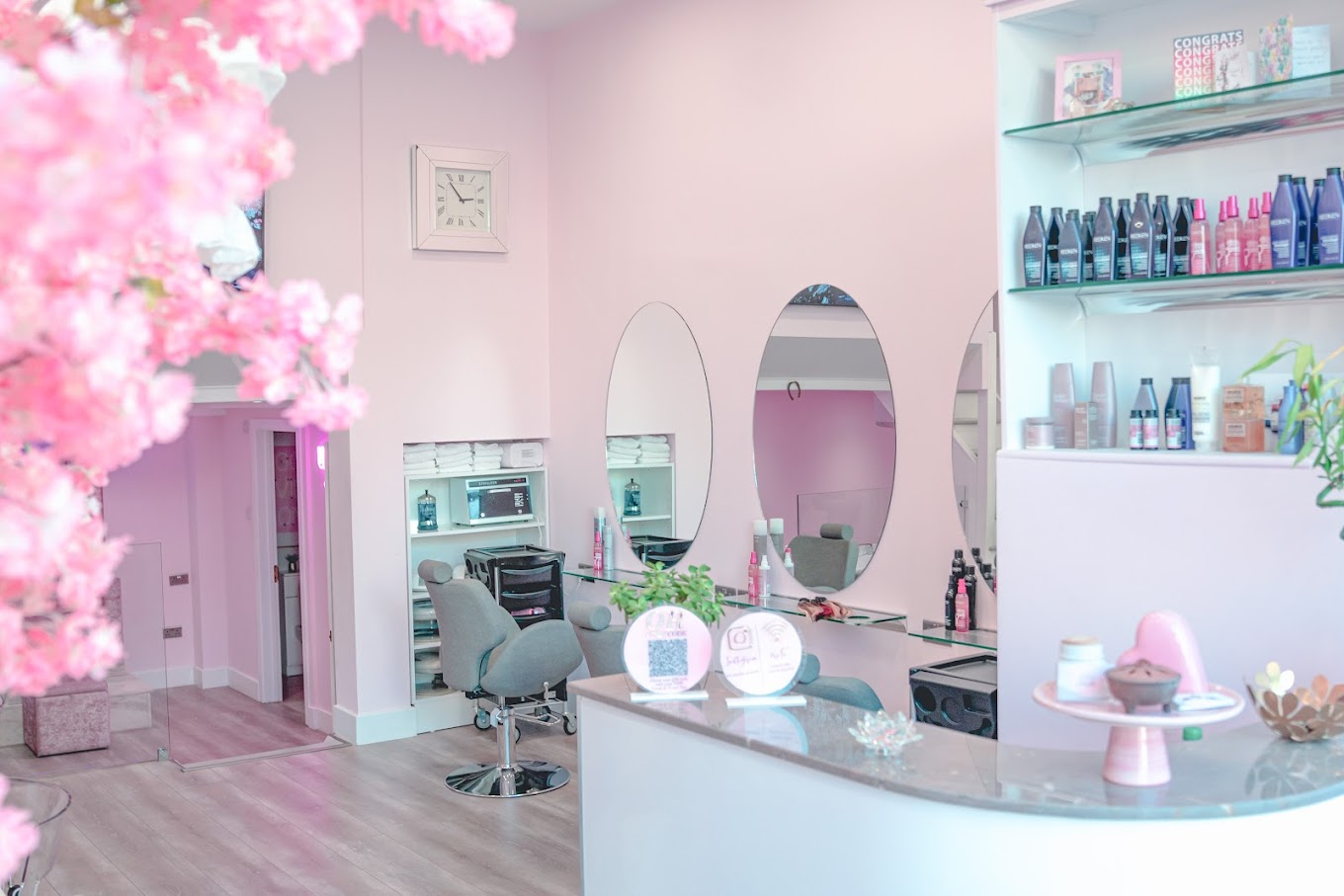 Spacious two-level salon with a big storefront window, offering a unique, elevated experience.