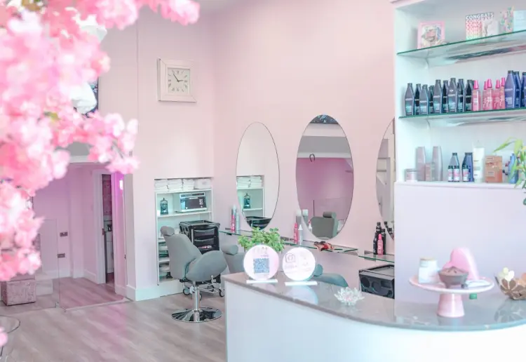 Spacious two-level salon with a big storefront window, offering a unique, elevated experience.