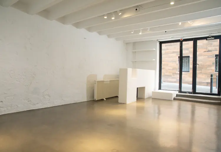 Glass-front gallery with hidden patio