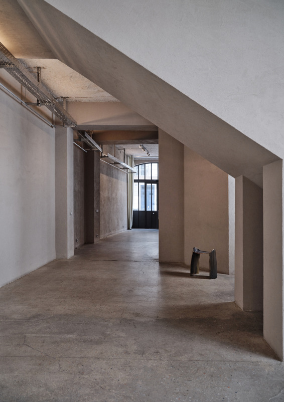 Minimalist gallery with concrete floors and walls
