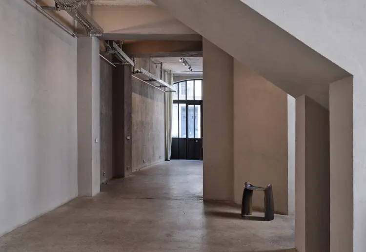 Minimalist gallery with concrete floors and walls