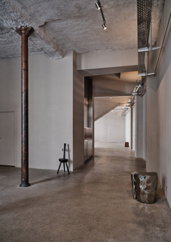 Minimalist gallery with concrete floors and walls
