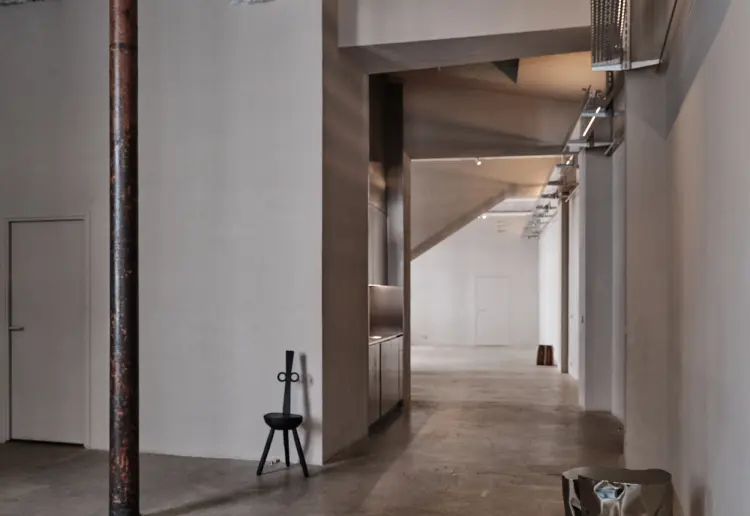 Minimalist gallery with concrete floors and walls