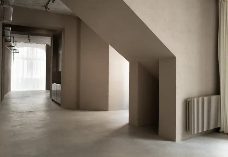 Minimalist gallery with concrete floors and walls