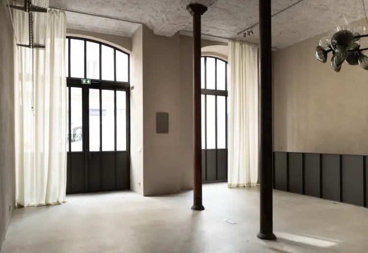 Minimalist gallery with concrete floors and walls