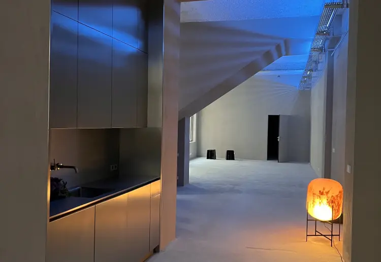 Minimalist gallery with concrete floors and walls