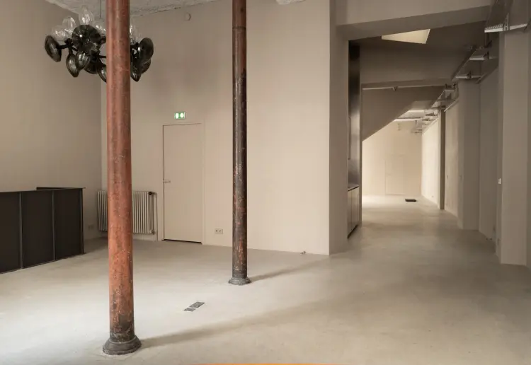 Minimalist gallery with concrete floors and walls